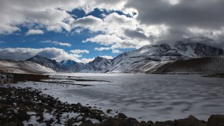 Clouds drift over a frozen Grant Lake Reservoir in a view from the lake's dam January 29 2012 in th