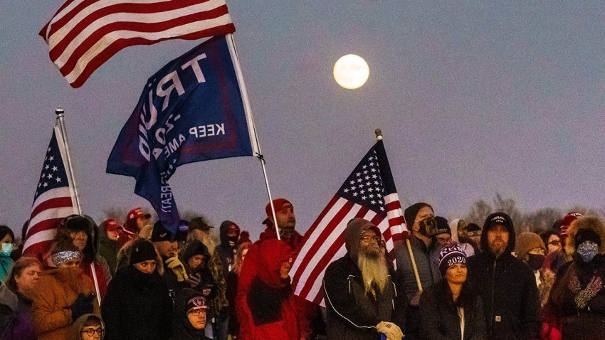 Supporters of U.S. President Donald Trump listen during a "Make America Great Again" rally at the Rochester International Airport in Rochester, Minnesota, Oct. 30, 2020.
