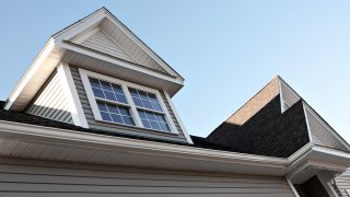 Close up view of a newly built house rooftop soffit and dormers.