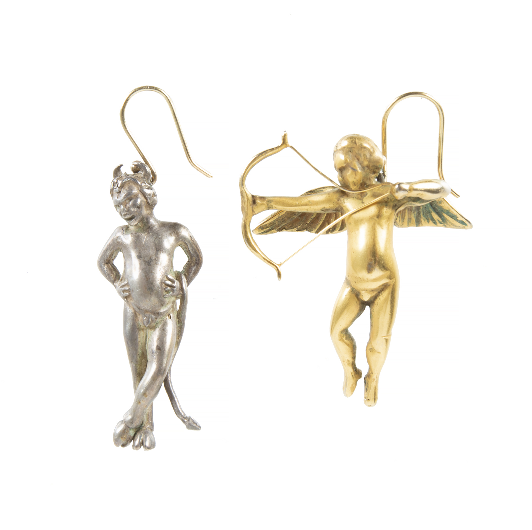 A custom-made pair of dangling earrings created by the late Los Angeles jewelry designer, Devon Page McCleary, in the 1980s, One is a solid silver devil and the other is a solid gold angel.