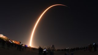 A SpaceX Falcon 9 rocke lifts off.