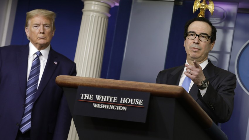 U.S. President Donald Trump, left, listens as Steven Mnuchin, U.S. Treasury secretary speaks during a news conference at the White House in Washington D.C., U.S. on Tuesday, April 21, 2020. The Trump administration vowed to stem job losses and rescue the oil industry with stimulus funds and other measures as the U.S. responds to a global glut in crude thats led to an historic rout in prices.