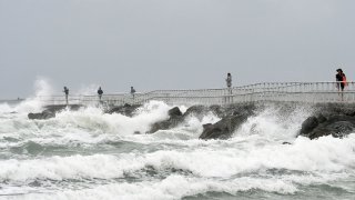 In this file photo, waves crash on the jetty at Lighthouse Point Park as Tropical Storm Isaias travels up the Atlantic coast on August 2, 2020 in Ponce Inlet, Florida. After weakening from a Category 1 hurricane, Isaias continued to bring rain and gusty winds to coastal Florida, causing beach erosion and power outages to thousands of homes.