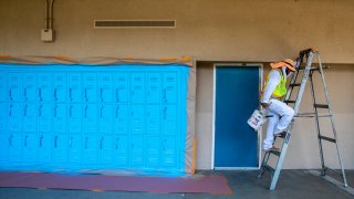 A painter works at a school.