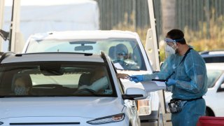 A COVID-19 testing site staff member uses a pulse oximeter to screen a driver at a drive-up testing site at the Orange County Fairgrounds in Costa Mesa, California, November 17, 2020. – US biotech firm Moderna on November 16, 2020 announced its experimental vaccine against Covid-19 was almost 95 percent effective, marking a second major breakthrough in the quest to end the pandemic.
Moderna released early results from a clinical trial with more than 30,000 participants, after American pharmaceutical company Pfizer and its German partner BioNTech last week said their vaccine was 90 percent effective. (Photo by Patrick T. Fallon / AFP) (Photo by PATRICK T. FALLON/AFP via Getty Images)