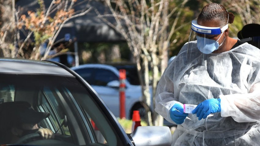 In this Nov. 23, 2020, file photo, a health worker prepares to perform a nasal swab sample at a COVID-19 rapid testing site at Barnett Park.