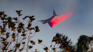 A fire-fighting jet makes a drop.