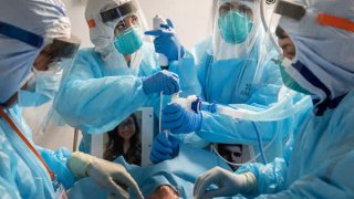 Medical workers wearing personal protective equipment (PPE) administer COVID-19 tests at a drive-thru testing site at the Alemany Farmers Market in San Francisco, California, U.S., on Thursday, Nov. 19, 2020.