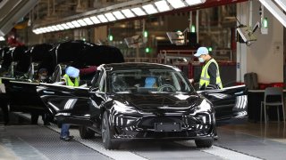 Employees work at the Tesla Gigafactory in Shanghai, east China, Nov. 20, 2020. U.S. electric car company Tesla in 2019 built its first Gigafactory outside the United States in the new Lingang area, with a designed annual production capacity of 500,000 units.