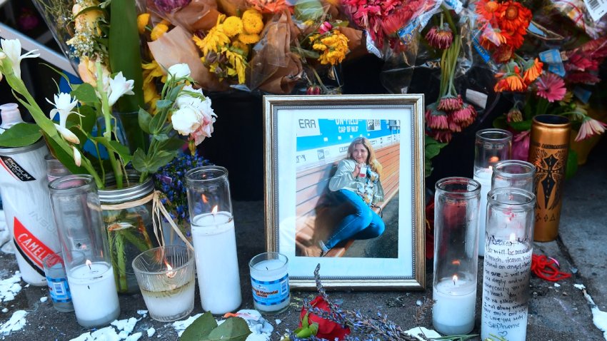 Flowers and a photograph are seen at a memorial for Melyda Corado, the assistant manager at the Silver Lake Trader Joe’s, who was killed in a July 21 shootout between police and a gunman in Los Angeles, California on July 23, 2018. – The gunman, Gene Evin Atkins, took hostages inside a supermarket in Los Angeles on Saturday after a gun battle with police, leaving a store employee dead before the suspect handcuffed himself and surrendered. The Los Angeles Police Department revealed on July 24 that Corado died as a result of police gunfire. (Photo by Frederic J. BROWN / AFP)        (Photo credit should read FREDERIC J. BROWN/AFP via Getty Images)