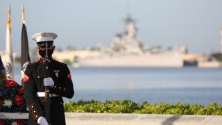A U.S. Marine stands in front of the USS Missouri during a ceremony to mark the anniversary of the attack on Pearl Harbor, Monday, Dec. 7, 2020, in Pearl Harbor, Hawaii. Officials gathered in Pearl Harbor to remember those killed in the 1941 Japanese attack, but public health measures adopted because of the coronavirus pandemic meant no survivors were present. The military broadcast video of the ceremony live online for survivors and members of the public to watch from afar. A moment of silence was held at 7:55 a.m., the same time the attack began 79 years ago. 