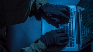 Hacker stealing password and identity, computer crime