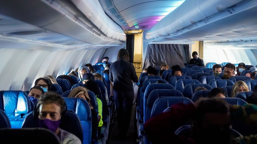 Masked passengers, aboard a Hawaiian Airlines flight.