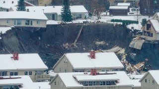Destroyed houses are seen in a crater left behind by a landslide in Norway