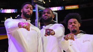 Anthony Davis #3, LeBron James #23 and Quinn Cook #2 of the Los Angeles Lakers pose for a photo as they get their 2019-20 NBA Championship ring during the ring ceremony before the game against the LA Clippers on December 22, 2020, at STAPLES Center in Los Angeles, California.