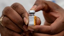 Dr. Michelle Chester holds a vial of the Covid-19 vaccine at Long Island Jewish Medical Center, on Dec. 14, 2020, in Queens, New York. As of December, more than 299,000 Americans have been killed by the virus.