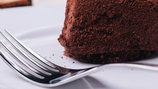Close up of chocolate cake and fork in the foreground