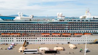 Medical personnel tend to passengers as they disembark from the Grand Princess cruise ship at the Port of Oakland in California on March 9, 2020. The cruise ship carrying thousands of people who were stranded for days due to a coronavirus outbreak docked near San Francisco.