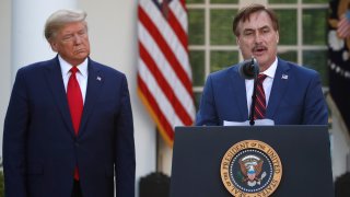 In this March 30, 2020, file photo, My Pillow CEO Mike Lindell speaks as President Donald Trump listens during a briefing about the coronavirus in the Rose Garden of the White House, in Washington, D.C.