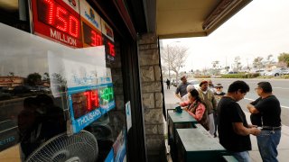 A line forms to buy lottery tickets.