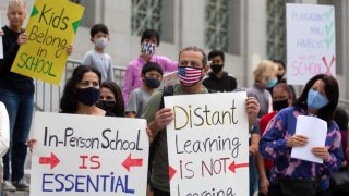 File Image: About 40 parents and their children, participate in a Open Our Schools Rally on the steps of Los Angeles City Hall on October 24, 2020 in Los Angeles, California. (Photo by Francine Orr/Los Angeles Times via Getty Images)