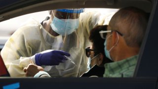 File Image: Staff and volunteers distribute the COVID-19 vaccine to people as they remain in their vehicles at The Forum in Inglewood Tuesday. The Forum is one of five mass-vaccination sites that opened Tuesday in Los Angeles county. The Forum on Tuesday, Jan. 19, 2021 in Inglewood, CA. (Al Seib / Los Angeles Times via Getty Images)