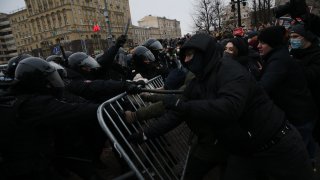 Russian policemen clash with participants of an unauthorized protest rally