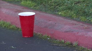 A red solo cup is seen outside a Miramar warehouse that hosted a New Year's Eve party against public health orders.