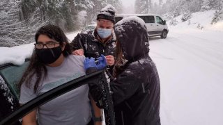 Oregon health workers who got stuck in a snowstorm on their way back from a COVID-19 vaccination event went car to car injecting stranded drivers before several of the doses expired