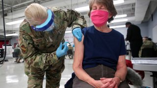 Sergeant Jennifer Callender (L) of the Illinois Air National Guard administers a Pfizer Covid-19 vaccine to Virginia Persha at a vaccination center established at the Triton College in River Grove, Illinois, on February 3, 2021.