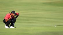 Tiger Woods lines up a shot on the 15th green during the final round of the Arnold Palmer Invitational golf tournament at Bay Hill, Sunday, March 25, 2012, in Orlando, Fla.