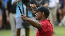 Tiger Woods celebrates on the 18th green after winning the Tour Championship golf tournament Sunday, Sept. 23, 2018, in Atlanta.