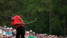 Tiger Woods tees off on the 12th hole during the fourth round of the Masters golf tournament Sunday, April 12, 2015, in Augusta, Ga.