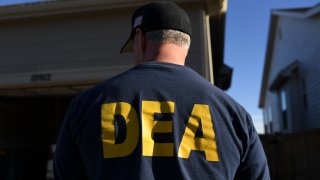 In this Jan. 31, 2019, file photo, a DEA agent is seen in Commerce City, Colorado.