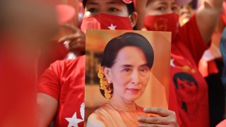 In this Feb. 1, 2021, file photo, a Myanmar migrant holds up an image of Aung San Suu Kyi during a demonstration outside the Myanmar embassy in Bangkok after Myanmar's military detained the country's de facto leader Suu Kyi and the country's president in a coup.