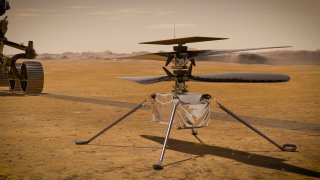 In this artist's concept, NASA's Ingenuity Mars Helicopter stands on the Red Planet's surface as NASA's Mars 2020 Perseverance rover (partially visible on the left) rolls away. Ingenuity made its first flight test on April 19, 2021.