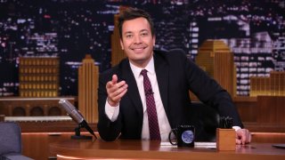 In this Nov. 16, 2018, file photo, host Jimmy Fallon sits at his desk on the set of "The Tonight Show Starring Jimmy Fallon."