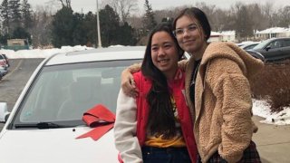 Hokule’a Taniguchi and Haley Bridges are all smiles next to the car Bridges gifted Taniguchi after winning it at a Chick-fil-A company party.