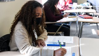 Giani Clarke,18, a senior at Wilson High School, takes a test in her AP Statistics class. The desks are doubled as a way to provide more social distancing.