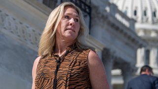 In this March 10, 2021, file photo, Rep. Marjorie Taylor Greene, R-Ga., is seen on the House steps during the vote on the $1.9 trillion COVID-19 relief package, the American Rescue Plan Act.