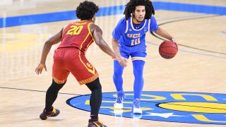 The Bruins face the Trojans in a men's basketball game.