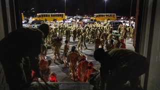 U.S. Army troops from the 10th Mountain Division collect their duffels after returning from a 9-month deployment in Afghanistan on December 08, 2020 in Fort Drum, New York.