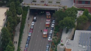 Several first responders at the scene of a pedestrian crash under a tunnel near San Diego City College on Monday, March 15, 2021.