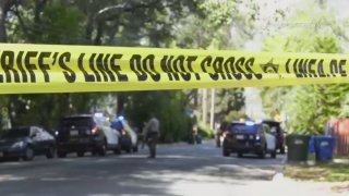 Deputies are seen at the site of a slaying in Altadena.