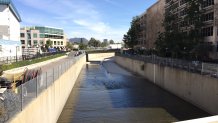 A view of the LA River today. The walls are now perpendicular, rather than sloped, and the channel has been slightly reworked. The river receives the Tujunga Wash just beyond the bend in the distance.