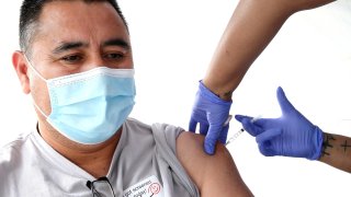 In this March 21, 2021, file photo, Feliciano Estrada receives a one shot dose of the Johnson & Johnson COVID-19 vaccine at a clinic targeting immigrant community members in Los Angeles, California. The clinic, run by the St. John's Well Child and Family Center, estimates it has vaccinated more than 100,000 people in the Los Angeles area amid reports of two undocumented women who were refused coronavirus vaccinations in Orange County Rite Aid stores. Rite Aid has called the refusals mistakes in a written statement.