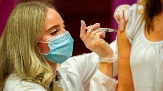 Pharmacist Madeline Acquilano inoculates a teacher with the Johnson & Johnson Covid-19 Vaccine at Hartford Hospital in Hartford, Connecticut, on March 3, 2021.