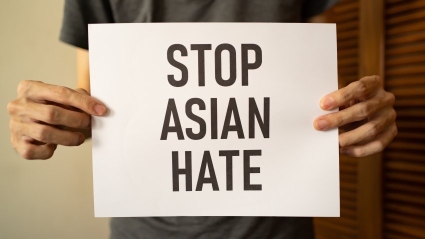 A man holding Stop Asian Hate sign