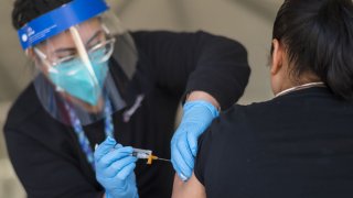A healthcare worker administers a dose of the Moderna Covid-19 vaccine to a farmworker at a vaccination clinic organized by the Santa Clara County Public Health Department at Christopher Ranch in Gilroy, California, U.S., on Thursday, March 4, 2021. Farmworkers have been one of the hardest hit communities since the start of the pandemic. Photographer: Nic Coury/Bloomberg via Getty Images