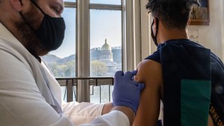 Antonio Sneed, 19, of Morgantown, West Virginia receives the vaccine while overlooking the West Virginia Capitol Building in Riggleman Hall. The Kanawha-Charleston Health Department led a vaccination effort on the campus of the University of Charleston. 1,800 doses of the Johnson & Johnson Janssen Covid-19 vaccine were on hand to be given out to all persons aged 16 years and older.